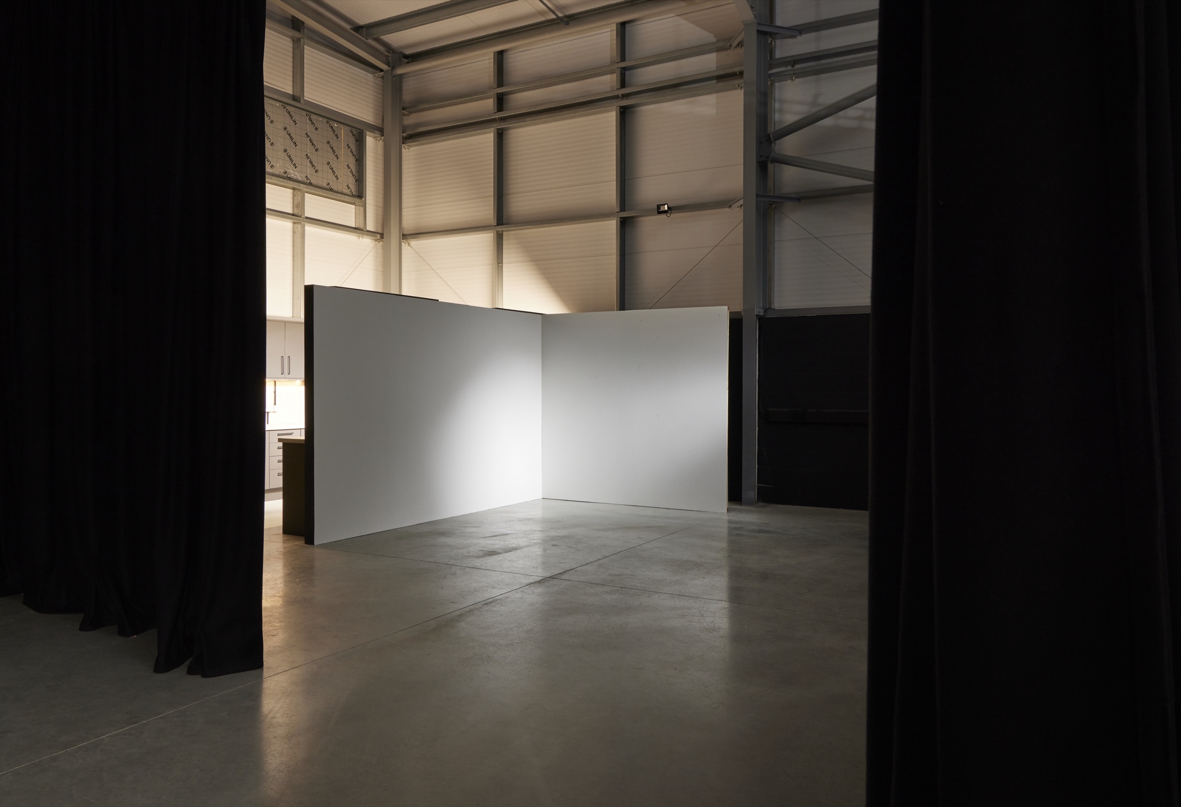 The Hopclover One shoot floor, walled with white flats, with the production kitchen along the far wall